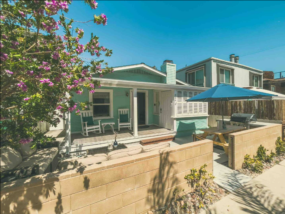 house with a patio and deck chairs